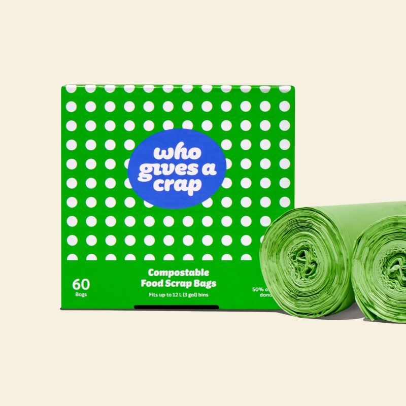 Two rolls of compostable food scrap bags next to a green and white polka-dotted box that contains 60 bags designed to fit up to 12L bins.